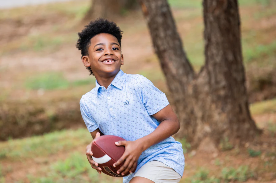 BOYS' SHORT SLEEVE PRO PERFORMANCE POLO IN POWDER BLUE GOLF CART PRINT